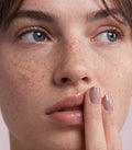 Close-up beauty photo of manicured nails with a nude and gold gel polish finish